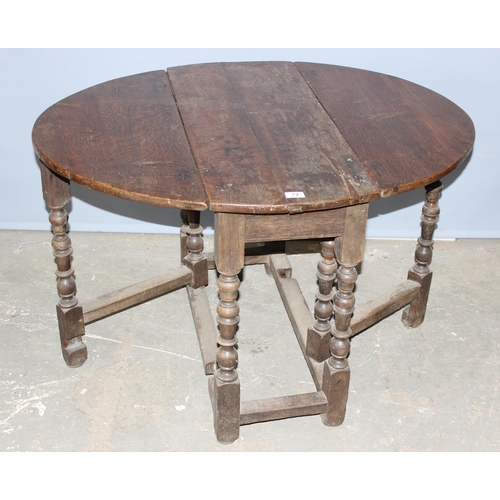 72 - An 18th century oak drop leaf table with single drawer and turned legs