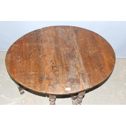 72 - An 18th century oak drop leaf table with single drawer and turned legs