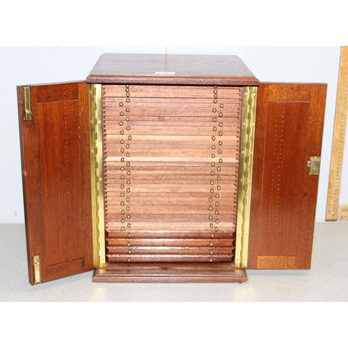 3 - A 20th century oak coin collector's cabinet containing 37 small drawers with turned brass handles an... 