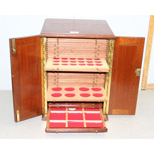 3 - A 20th century oak coin collector's cabinet containing 37 small drawers with turned brass handles an... 