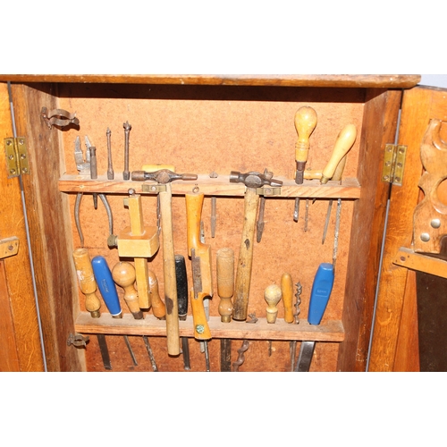 909 - An unusual good quality vintage wooden wall hanging tool box contents, approx 52cm wide