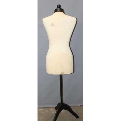 93 - A female form mannequin on wooden base