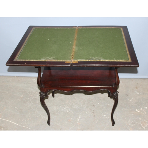 97 - An antique marquetry inlaid card table with fold over top and baize and leather lined interior, appr... 