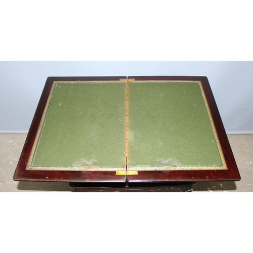 97 - An antique marquetry inlaid card table with fold over top and baize and leather lined interior, appr... 