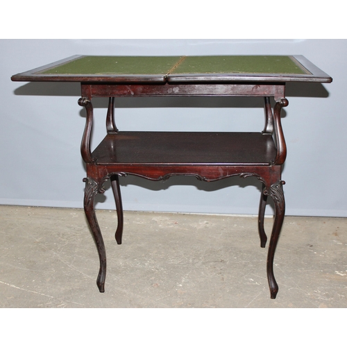 97 - An antique marquetry inlaid card table with fold over top and baize and leather lined interior, appr... 