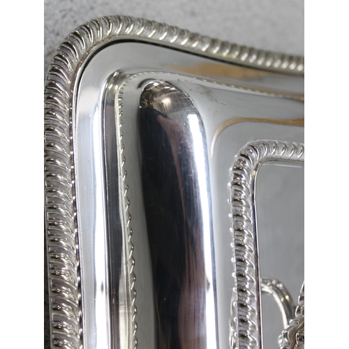 1002 - 3 antique silver plated entrée dishes of rectangular shape with gadrooned borders, one bearing armor... 