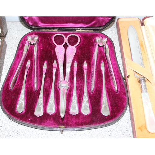 1011 - 4 boxes silver plated items to inc a set of grape scissors and nut picks and crackers, a cruet set a... 