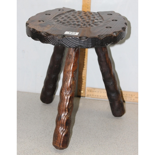 123 - An interesting stained pine 3 legged milking stool with carved horseshoe detail to the seat