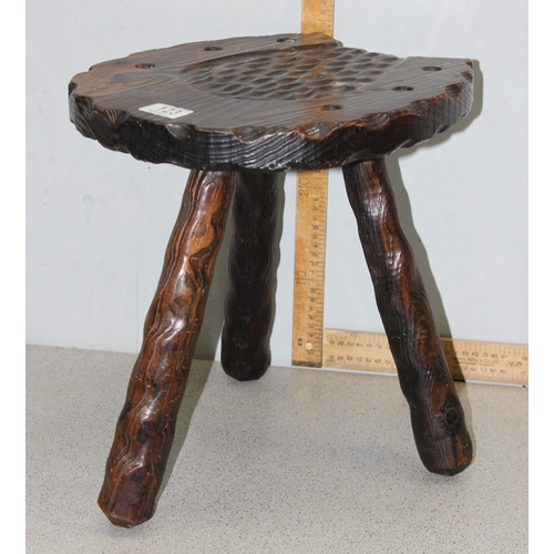 123 - An interesting stained pine 3 legged milking stool with carved horseshoe detail to the seat