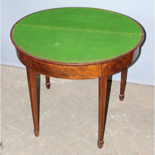 141 - Antique mahogany demi-lune folding card table with spade feet