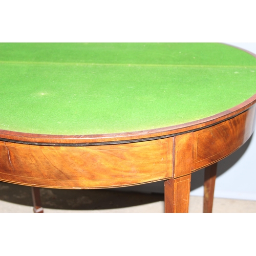 141 - Antique mahogany demi-lune folding card table with spade feet