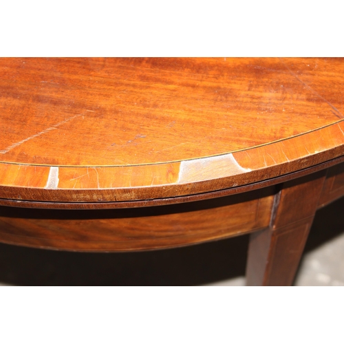 141 - Antique mahogany demi-lune folding card table with spade feet