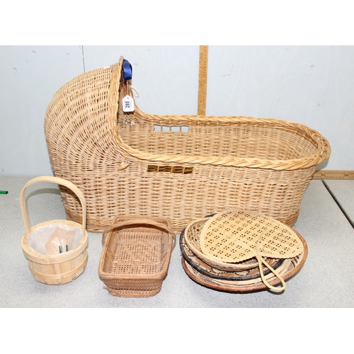 285 - A vintage wicker crib and a number of other wicker baskets