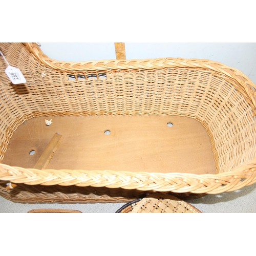 285 - A vintage wicker crib and a number of other wicker baskets