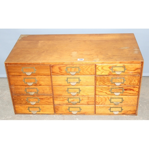 144 - A mid-century bank of pine fronted filing drawers, 15 drawers in 5x3 formation, no makers marks, app... 