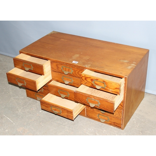 144 - A mid-century bank of pine fronted filing drawers, 15 drawers in 5x3 formation, no makers marks, app... 