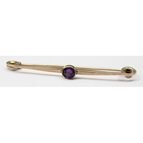 1111 - 9ct gold brooch set with purple stone, approx 1.17g gross, approx 4cm