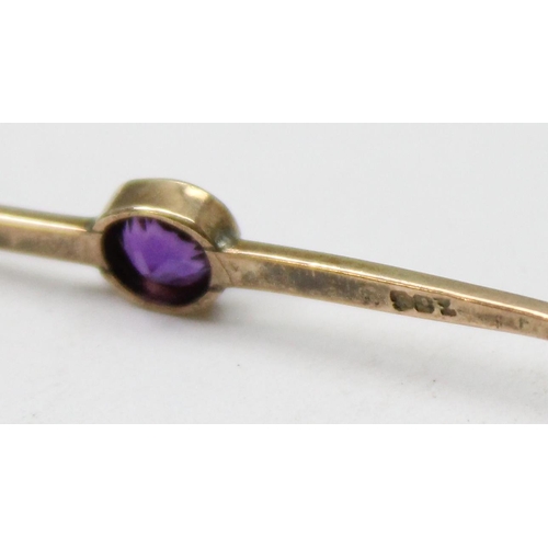 1111 - 9ct gold brooch set with purple stone, approx 1.17g gross, approx 4cm