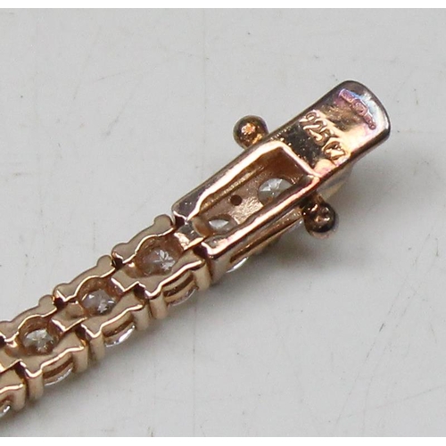 1114A - A 925 silver gilt and white stone set tennis bracelet