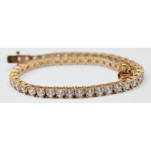 1114A - A 925 silver gilt and white stone set tennis bracelet