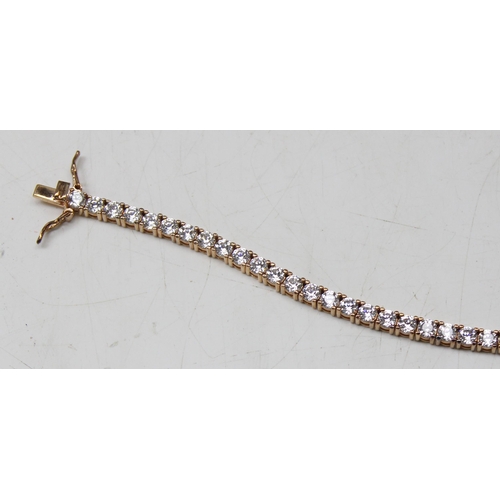 1114A - A 925 silver gilt and white stone set tennis bracelet