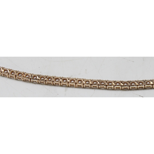 1114A - A 925 silver gilt and white stone set tennis bracelet