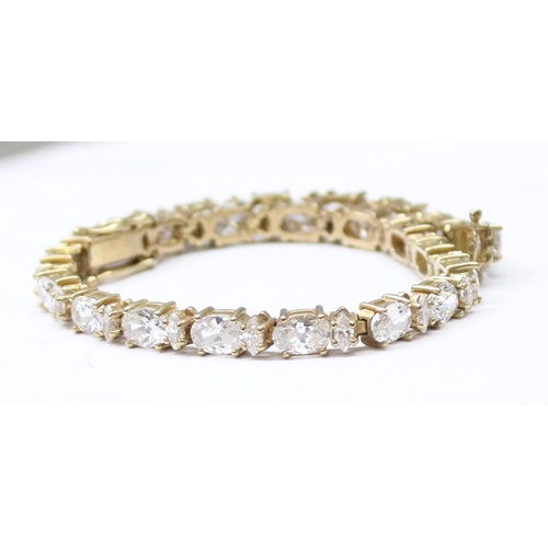 1116 - 9ct gold tennis bracelet set with white stones, approx 15.01g gross, 20cm