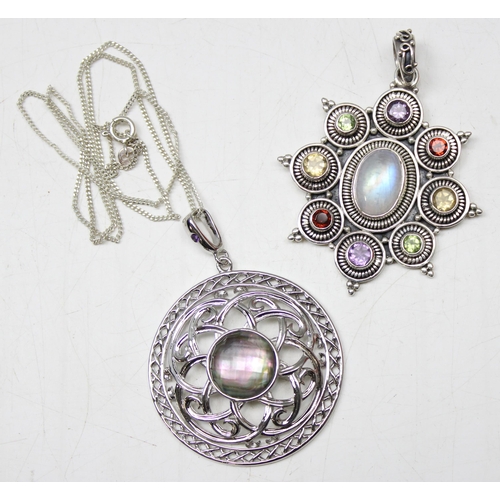 1126 - 2 silver pendants 1 set with central coloured glass stone on chain, the other with multiple coloured... 