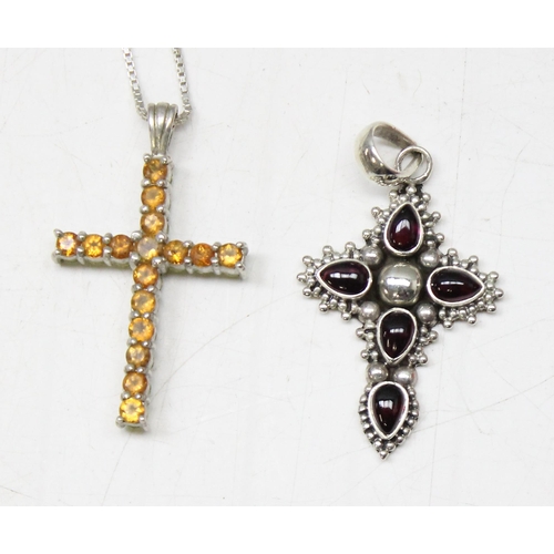 1130 - 4 silver pendants, 3 on chains to include 3 crucifixes and another gothic style pendant set with col... 