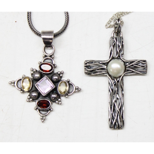 1130 - 4 silver pendants, 3 on chains to include 3 crucifixes and another gothic style pendant set with col... 