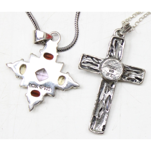 1130 - 4 silver pendants, 3 on chains to include 3 crucifixes and another gothic style pendant set with col... 