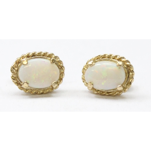 1163 - A pair of 9ct gold and opal stud earrings, both marked and XRF confirmed