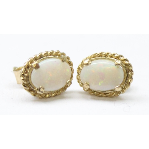 1163 - A pair of 9ct gold and opal stud earrings, both marked and XRF confirmed