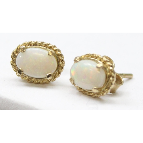 1163 - A pair of 9ct gold and opal stud earrings, both marked and XRF confirmed