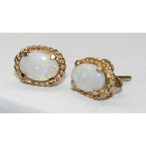 1163 - A pair of 9ct gold and opal stud earrings, both marked and XRF confirmed