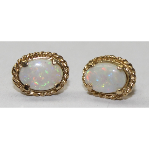 1163 - A pair of 9ct gold and opal stud earrings, both marked and XRF confirmed