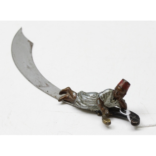 1621 - A Bergman style cold painted spelter letter opener formed as a Scimitar sword with small recumbent m... 