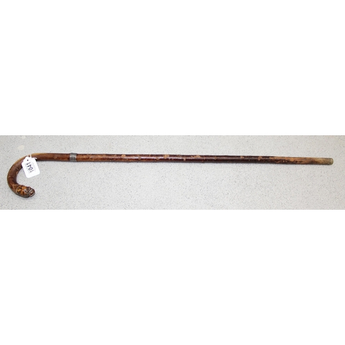 1041 - A rare antique silver mounted walking stick with carved muzzled dogs head terminal, the silver colla... 