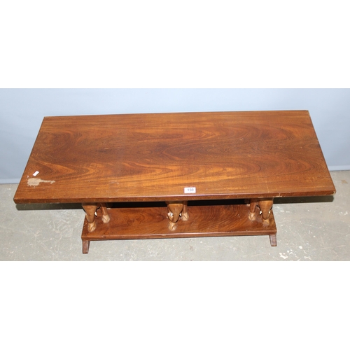 150 - A vintage wooden coffee table with carved elephant supports, approx 114cm wide