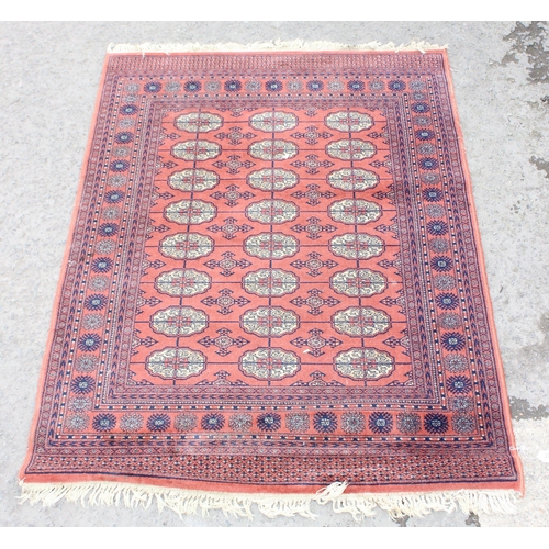 202 - A Bokhara style rug of salmon ground, approx 210cm x 140cm