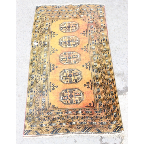 205 - A hand made terracotta ground Persian rug, approx 205cm x 102cm