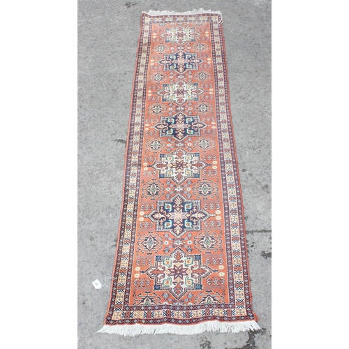 207 - A vintage hand made red ground Kurdistan Kelleigh type runner rug, approx 290cm x 75cm