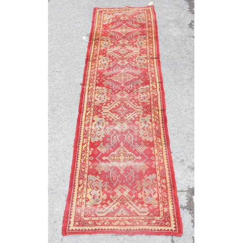 215 - A vintage red ground runner rug, likely Turkish, approx 360cm x 94cm