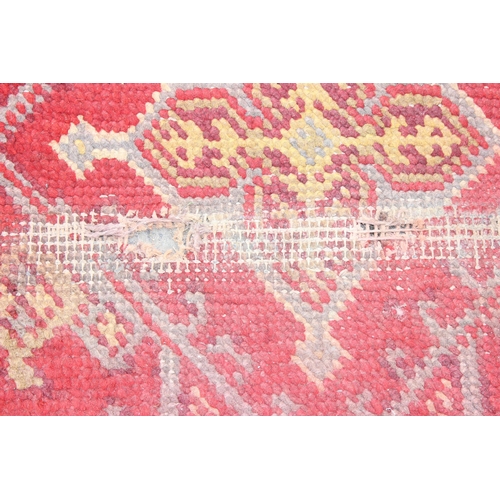 215 - A vintage red ground runner rug, likely Turkish, approx 360cm x 94cm