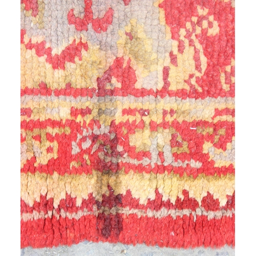 215 - A vintage red ground runner rug, likely Turkish, approx 360cm x 94cm