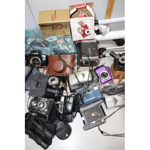 707 - A large box of assorted cameras and a telescope etc