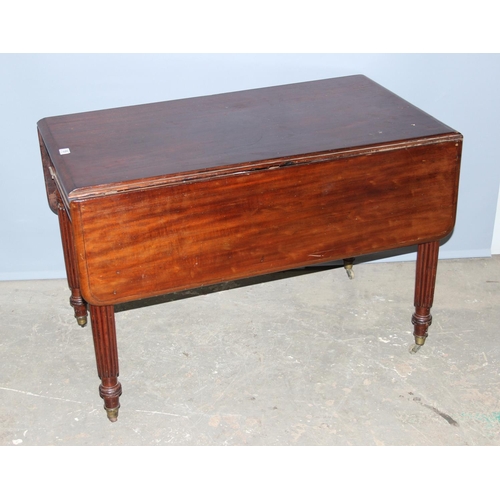 135 - An antique mahogany Pembroke table with reeded legs, single drawer and brass castors, approx 116cm w... 