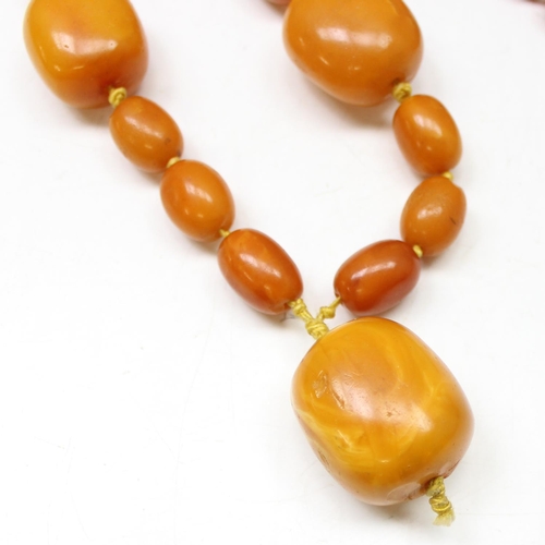 1174 - A large vintage amber coloured bead necklace, believed to be Amber on individually strung and knotte... 