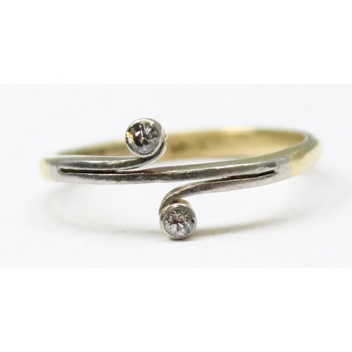 1185 - A 15ct gold ring set with 2 small diamonds in crossover setting, mark obscured but XRF tested at 15c... 