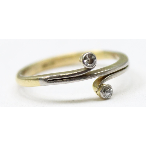 1185 - A 15ct gold ring set with 2 small diamonds in crossover setting, mark obscured but XRF tested at 15c... 